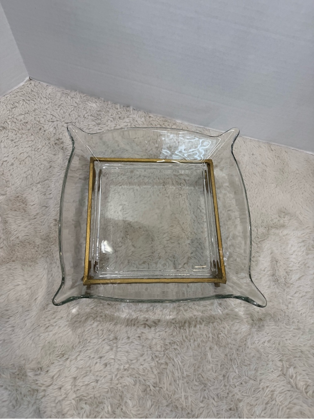 Vintage clear heavy glass setting atop a gold-tone metal caddy stand